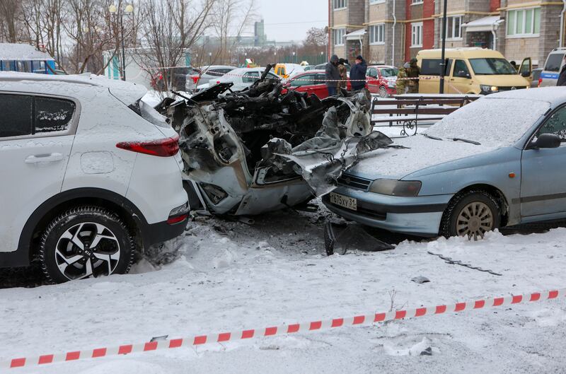 A destroyed car in a courtyard of a multi-storey apartment building after what local authorities say was a Ukrainian military strike in the city of Belgorod, Russia. Reuters
