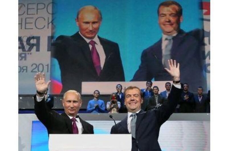 Russia's prime minister, Vladimir Putin, left, and president Dmitry Medvedev greet United Russia party members at the United Russia Party Congress in Moscow. YEKATERINA SHTUKINA / RIA NOVOSTI / KREMLIN POOL / EPA