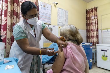 A health worker administers the Bharat Biotech Covaxin vaccine to a woman at a centre set up in New Delhi, India. Bloomberg
