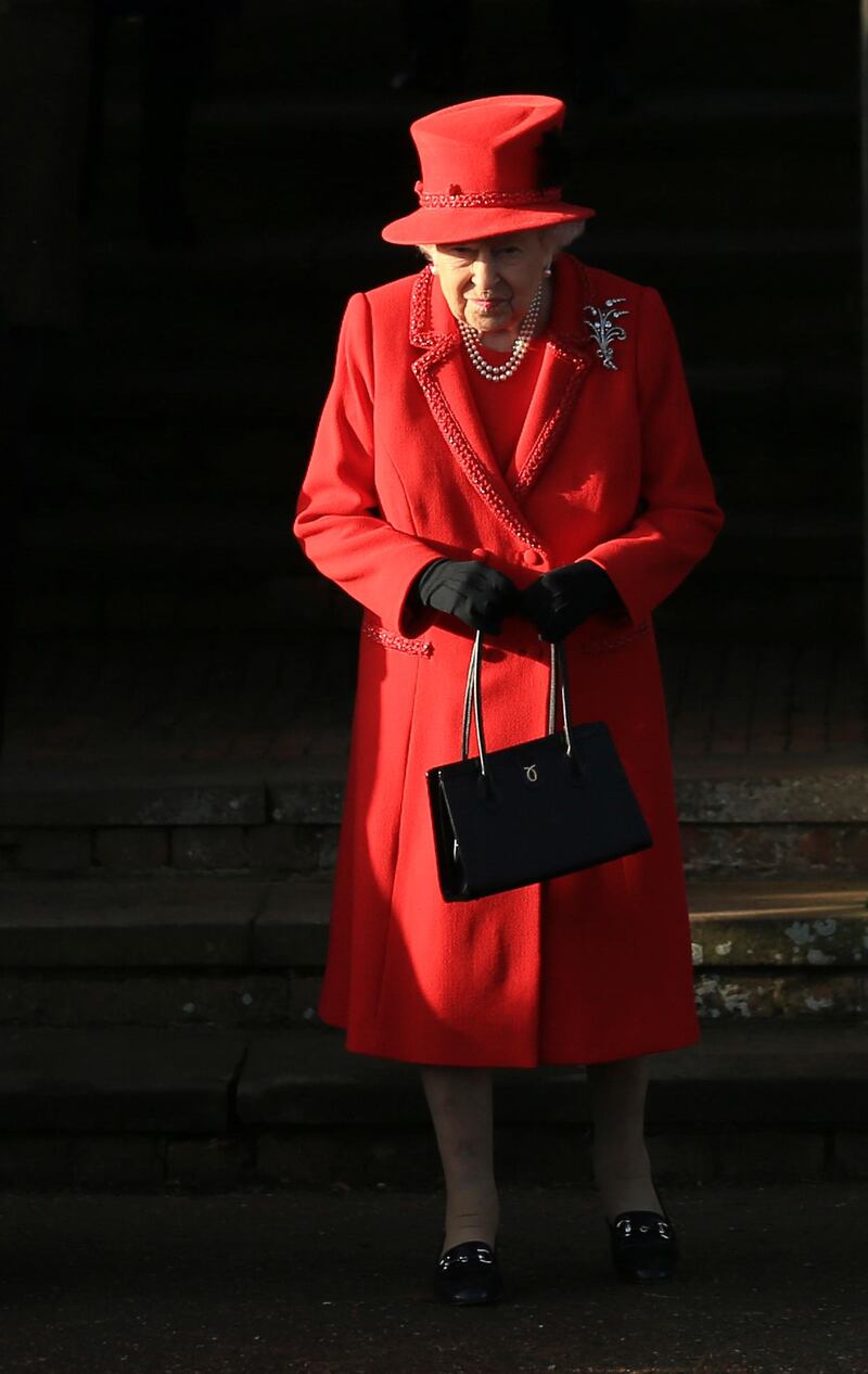 Britain's Queen Elizabeth II waits for her car after attending a Christmas day service at the St Mary Magdalene Church. AP