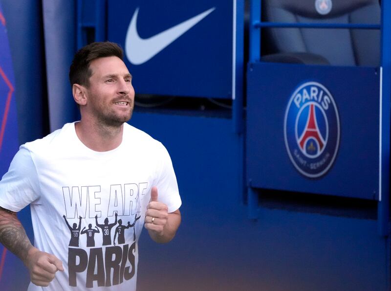 PSG's Lionel Messi runs during players presentations before the French League One soccer match between Paris Saint Germain and Strasbourg, at the Parc des Princes stadium in Paris.