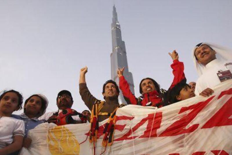 Nasr Al Neyadi, in red, cheers with supporters after free-falling from the Burj Khalifa in 2010. The divers made the jump after the inauguration of the building, covering a descent of 672 metres.