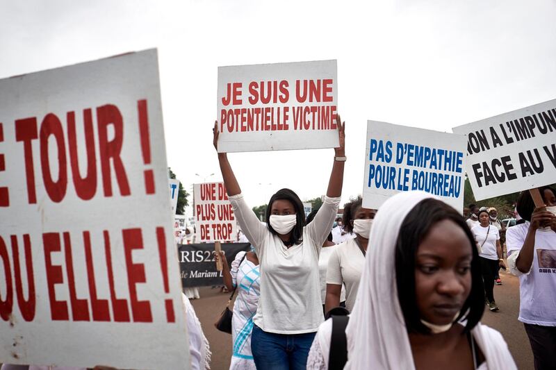 A protester holds a placard reading "I am a potential victim" in Bamako, during a demonstration against violence against women in Mali, a few days after the arrest of famous kora player Sidiki Diabate for the alleged beating and kidnapping of his girlfriend. AFP