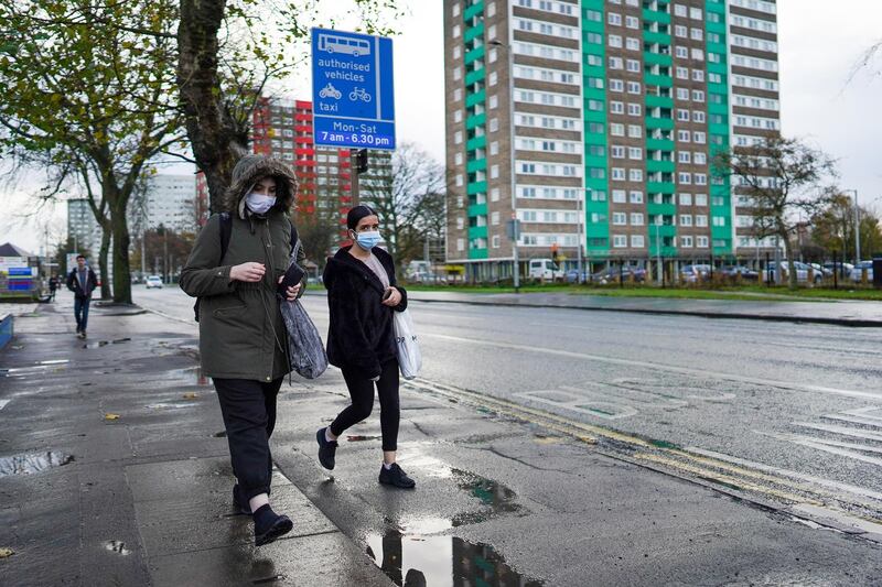 Two women wearing face masks walk down the street outside Hull Royal Infirmary in Hull, England. Hull recorded 726.8 new cases per 100,000 people in the week to November 7, nearly triple the national rate for England that same week. Getty Images