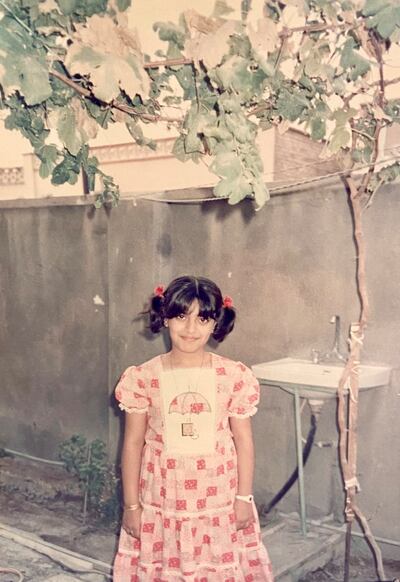 A young Asmaa in her grandparents' garden in Basra wearing the necklace inscribed with the word 'Allah' that her grandmother gave her. Photo: Asmaa Al Allak