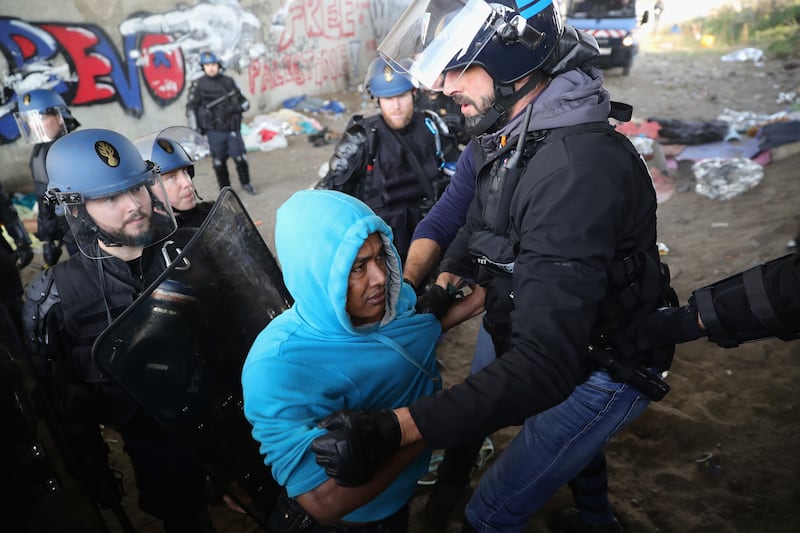 Police stop a migrant from returning