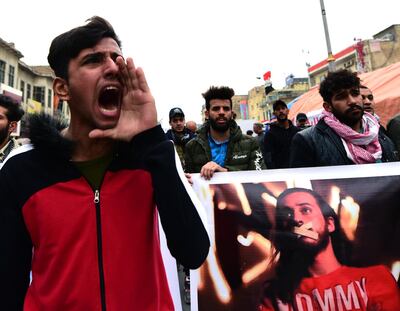 epa08133314 Iraqi protesters chant slogans as they carry the picture of a protester who was kidnapped by unknown gunmen during a protest at the Al Tahrir square in central Baghdad, Iraq, 16 January 2020.  Dozens of protesters and activists have been kidnapped by unknown actors due to their participation in anti-government protests that started in 01 October 2019 in Iraq, humen rights groups said. Protesters are calling for the resignation of all senior officials in the country.  EPA/MURTAJA LATEEF