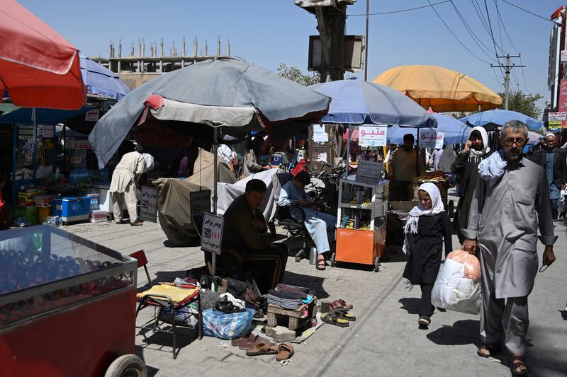 People at a market in Kot-e Sangi, in Kabul. AFP