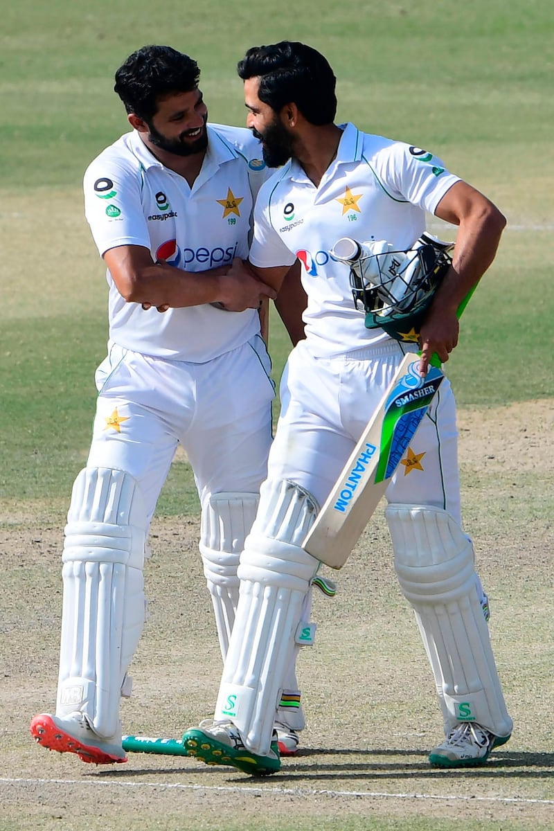 Pakistan's Fawad Alam, right, and Azhar Ali celebrate their victory on the fourth day of the first Test against South Africa at the National Stadium in Karachi on Friday. AFP
