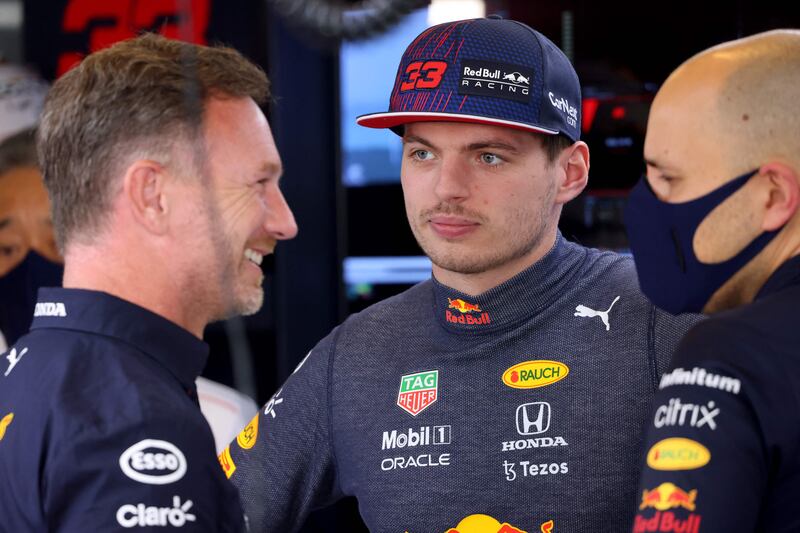 Red Bull's Dutch driver Max Verstappen speaks with team principal Christian Horner in the pits of the Yas Marina Circuit during the first free practice session of the Abu Dhabi Formula One Grand Prix on December 10, 2021. AFP