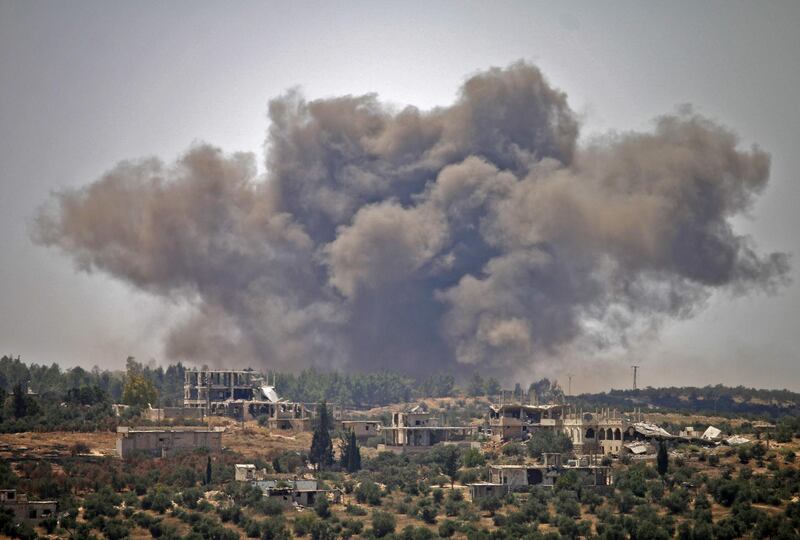 Smoke rises above opposition held areas of the city of Deraa during airstrikes by Syrian regime forces. Mohamad Abaazeed / AFP Photo