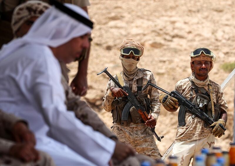 Yemeni soldiers stand guard during a graduation of new police cadets in Mukalla. AFP