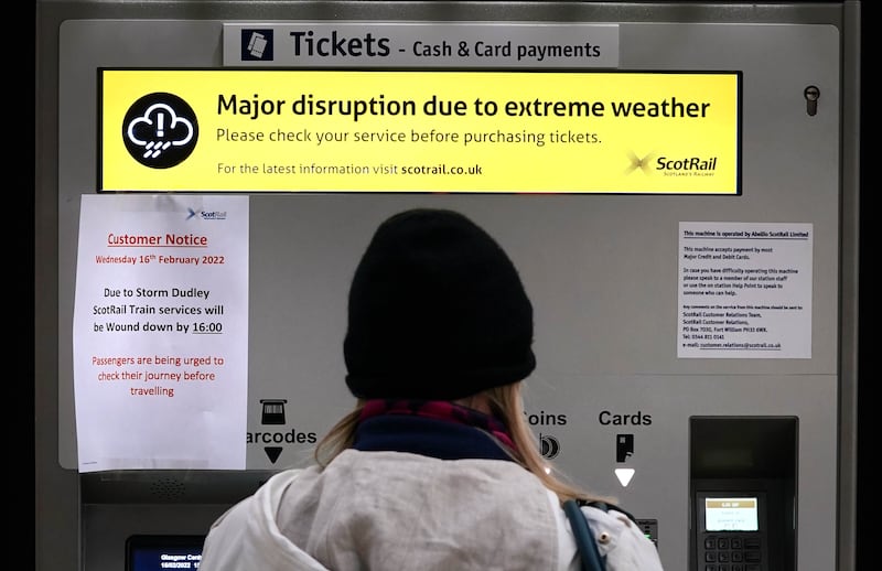 Weather warnings on a ticket machine at Glasgow Central Station. PA