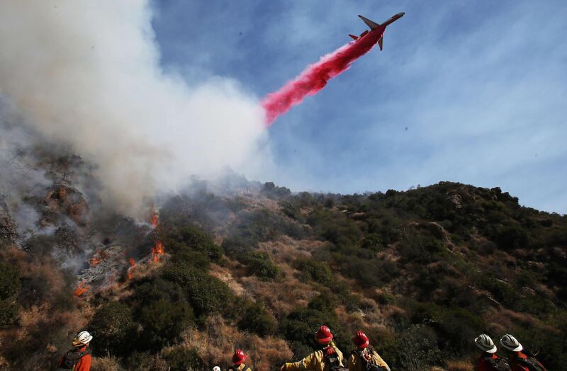 Am aircraft drops the fire retardant Phos-Chek during a wildfire threatening a nearby hillside home in the Pacific Palisades neighbourhood  in Los Angeles, California. Getty / AFP