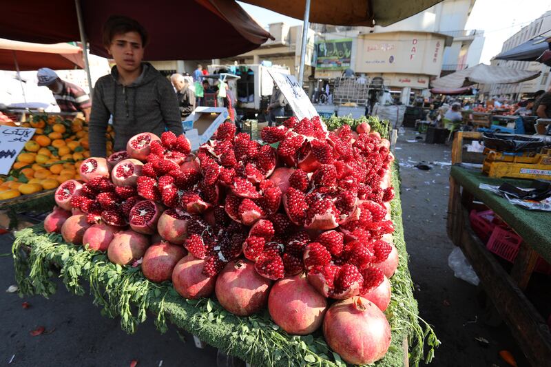 An Iraqi street vendor sells fruit at the Shorjah market in central Baghdad. Inflation in Iraq reached 7.2 per cent in September but is projected to ease in the coming months, according to the IMF. EPA / Ahmed Jalil