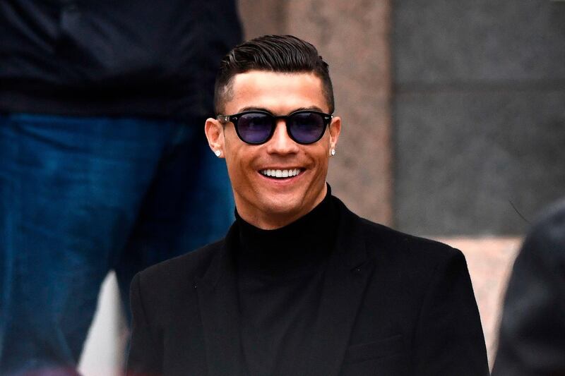 (FILES) In this file photo taken on January 22, 2019 Juventus' forward and former Real Madrid player Cristiano Ronaldo smiles as he leaves after attending a court hearing for tax evasion in Madrid . Cristiano Ronaldo will not face rape charges in Nevada, prosecutors said on July 22, 2019. / AFP / OSCAR DEL POZO
