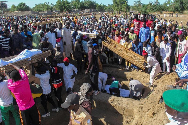 Mourners attend the funeral of 43 farm workers in Zabarmari, about 20 kilometres from Maiduguri, Nigeria, after they were killed by Boko Haram fighters in rice fields near the village of Koshobe. The victims were labourers from Sokoto state in northwest Nigeria, roughly 1,000km (600 miles) away, who had travelled to the northeast to find work. AFP