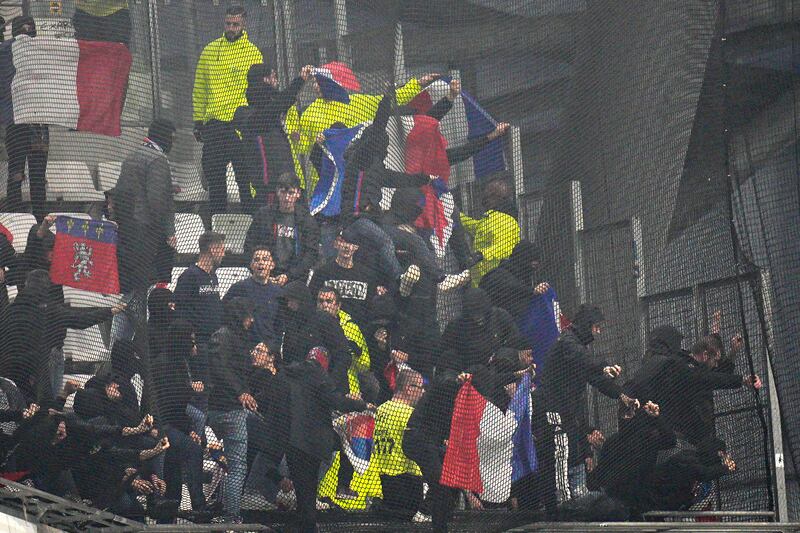 Lyon fans trying to break the net on the stands prior to the match against Lyon at Stade Velodrome. AP