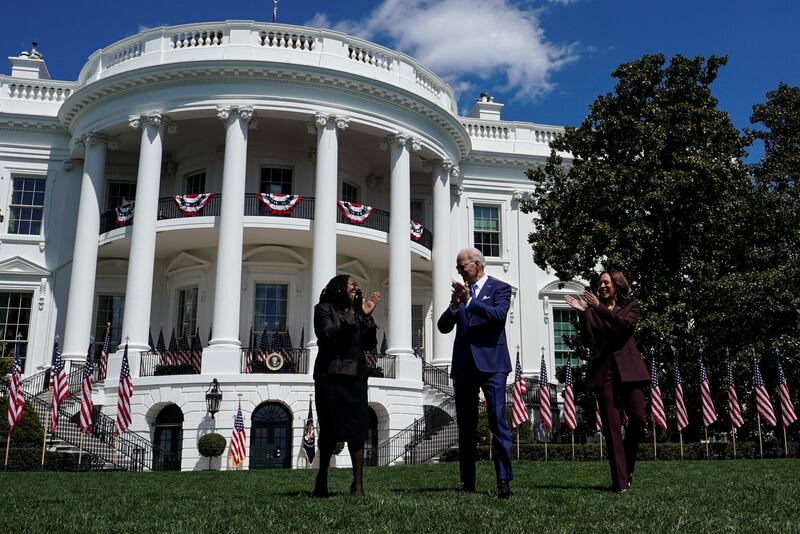 US President Joe Biden is flanked by Ketanji Brown Jackson and Vice President Kamala Harris as they arrive for the celebration. Reuters