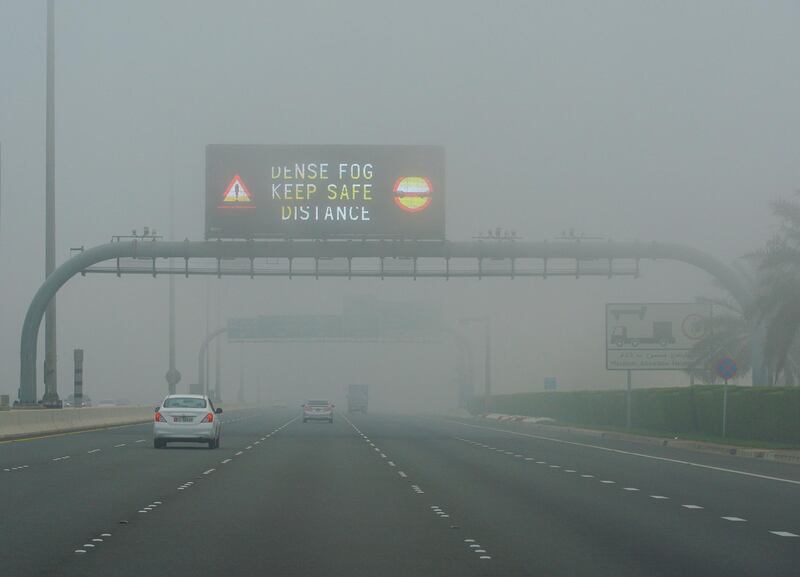 A road sign warns drivers to take care during the dense fog, which lifted by mid-morning. Victor Besa / The National