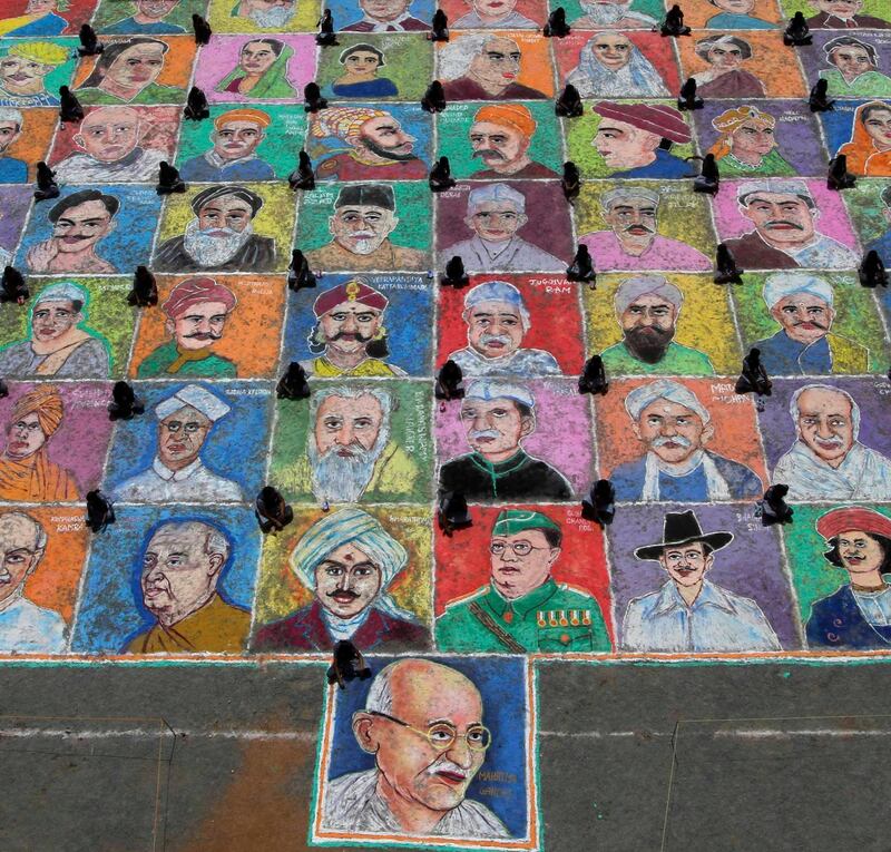 Students sit next to portraits after painting 65 images of Indian freedom fighters as part of India's Independence Day celebrations at the Velammal Vidyalaya high school in the southern Indian city of Chennai August 13, 2011. Sixty-five students gathered on Saturday to make a 6500 square foot painting with dry paints, the school said. India commemorates its 65th Independence Day on August 15.  REUTERS/Babu (INDIA - Tags: EDUCATION POLITICS SOCIETY ANNIVERSARY IMAGES OF THE DAY) *** Local Caption ***  DEL08_INDIA-_0813_11.JPG