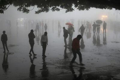 TOPSHOT - This photo taken on May 2, 2018 shows people walking under heavy rainfall in the northern hill town of Shimla in Himachal Pradesh state.
Dust storms tore across northern India killing at least 77 people and injuring 143 as trees and walls were flattened by powerful winds, officials said May 3.

 / AFP PHOTO / -