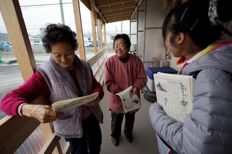 Izumi Tsukahara, 20, right, a volunteer of Peace Boat Disaster Relief Volunteer Center, distribute newspaper to the residents of temporary house, Mieko Iwai, 77, left, and Ykiko Utsumi, 77, in Ishinomaki, Miyagi, Japan on Feb 29, 2012. Both Iwai and Utsumi lost their houses by the massive tsunami hit northern Japan on March 11, 2011.
Photo by Kuni Takahashi