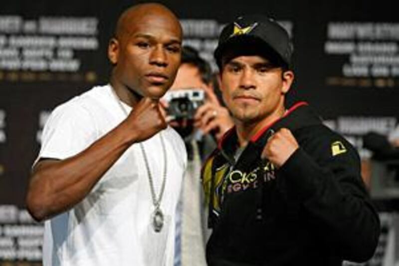 Floyd Mayweather Jr, left, and Juan Manuel Marquez pose during their final news conference ahead of tonight's fight.