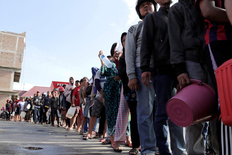 People line up for fuel at a petrol station in Palu, Central Sulawesi, Indonesia.  EPA