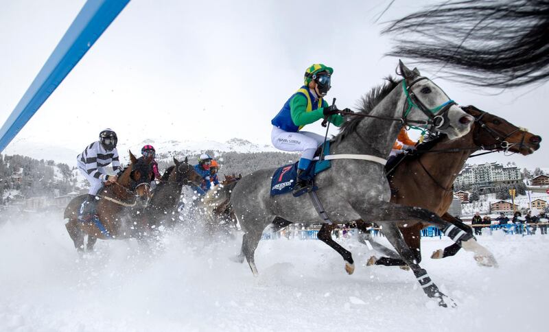 Participants of the flat race in action during the horse race on the frozen Lake on the first weekend of the white Turf races in St. Moritz, Switzerland. EPA