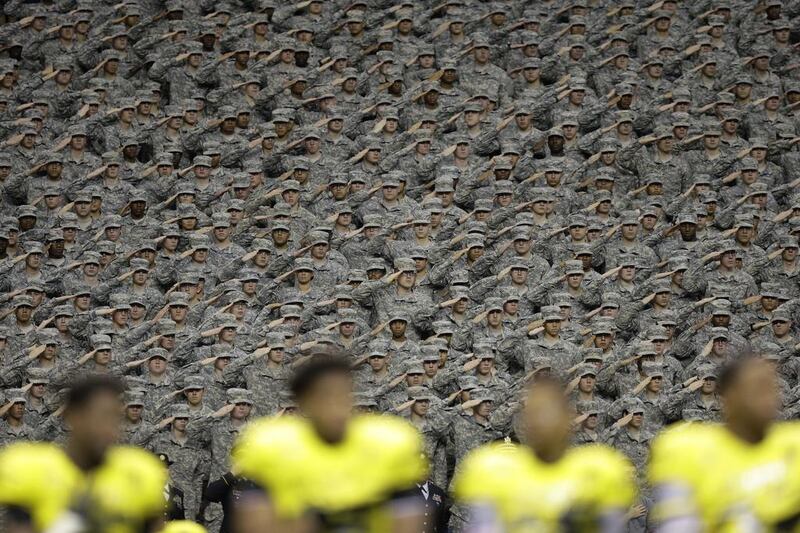 Members of the Army salute during the National Anthem before the US. Army All-American Bowl high school football game, in San Antonio. Eric Gay / AP