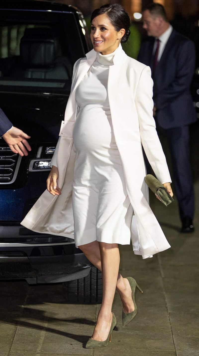 Meghan, Duchess of Sussex, wears a Calvin Klein dress and Amanda Wakeley coat at a gala performance of 'The Wider Earth' at the Natural History Museum in London on February 12, 2019. AFP