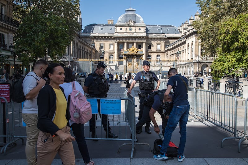 Policemen secure the access to the courthouse in Paris. EPA