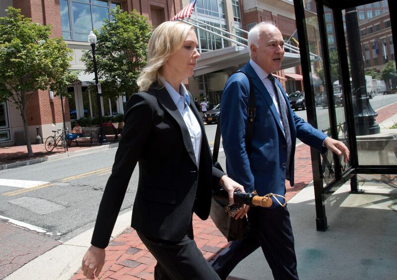 Paul Manafort's former bookkeeper Heather Washkuhn, left, walks to the Alexandria Federal Courthouse in Alexandria, Va., Thursday, Aug. 2, 2018, to testify at the trial of President Donald Trump's former campaign chairman's tax evasion and bank fraud trial. Washkuhn testified that Manafort kept her in the dark about the foreign bank accounts he was using to buy millions in luxury items and personal expenses. (AP Photo/Manuel Balce Ceneta)