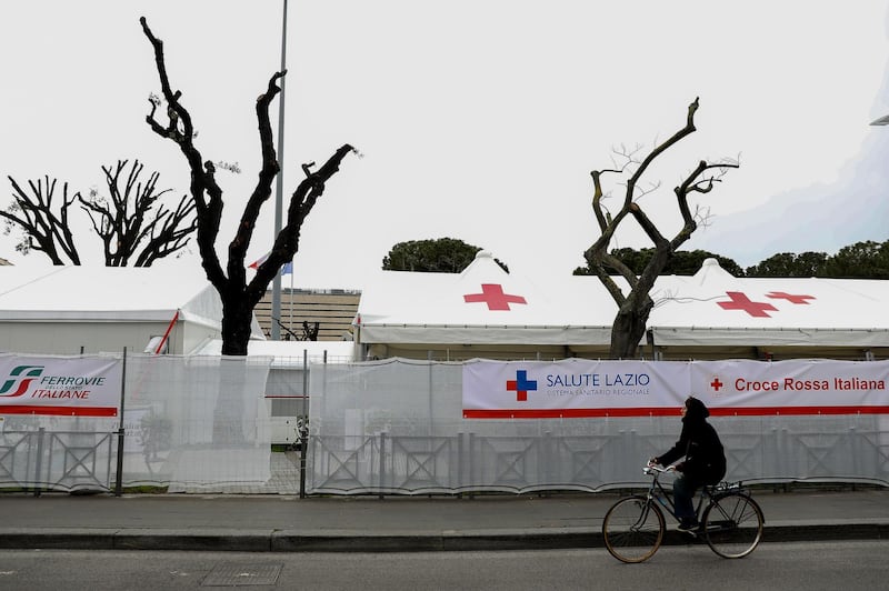 A cyclist passes a vaccination centre, operated by the Italian Red Cross, closed due to suspension of the use of the AstraZeneca-Oxford vaccine in Rome, Italy. Bloomberg