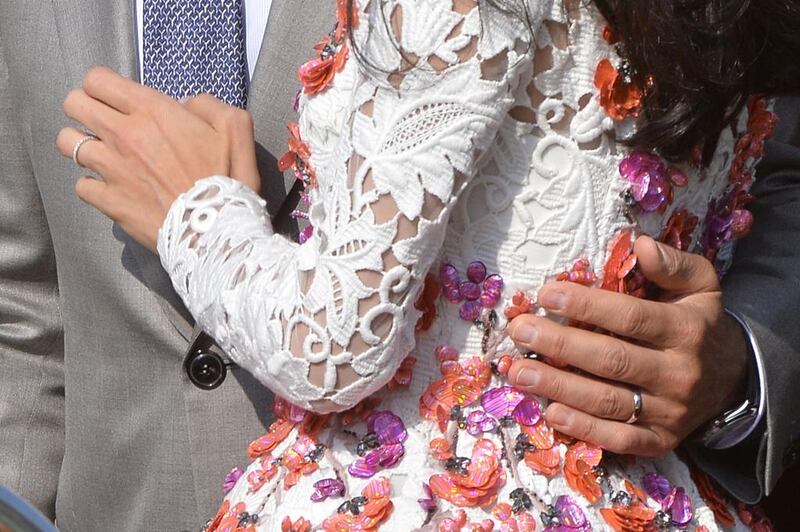 A close-up shows the wedding bands of George Clooney and his wife Amal. AFP 