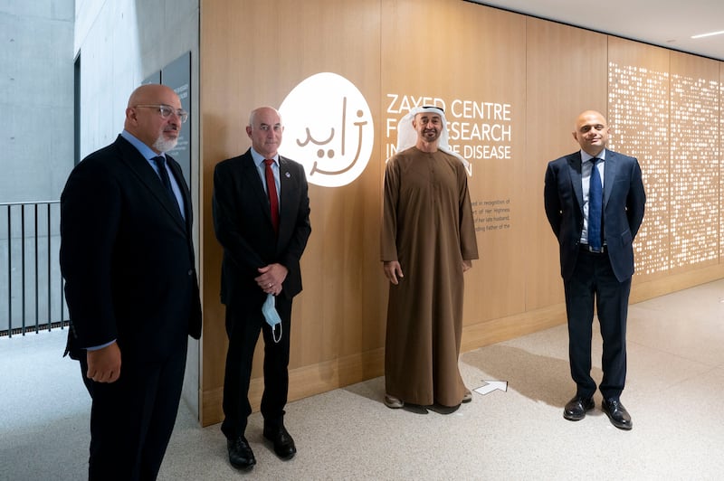 Sheikh Mohamed poses for a photograph with the former UK Secretary of State for Health and Social Care Sajid Javid and the former UK Secretary of State for Education Nadhim Zahawi.