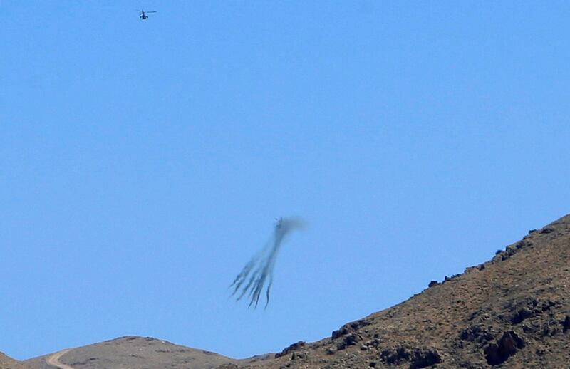 A Lebanese army helicopter fires during an offensive as pictured from the town of Ras Baalbek, Lebanon August 19, 2017. REUTERS/ Ali Hashisho