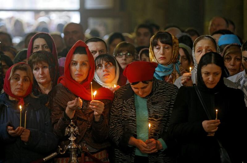 Georgian Orthodox believers attend a religious service marking the Annunciation at the Svetitskhoveli Cathedral in Mtskheta, near Tbilisi, Georgia. Zurab Kurtsikidze /EPA