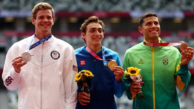 Men's pole vault gold medalist Armand Duplantis of Sweden, silver medalist Chris Nilsen of the United States, and bronze medalist Thiago Braz of Brazil pose with their medals.
