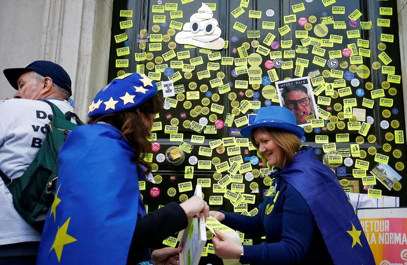 EU supporters, calling on the government to give Britons a vote on the final Brexit deal, attach post sticks outside the Cabinet Office. Reuters