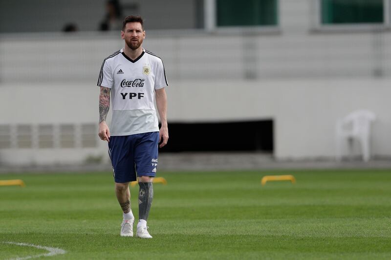 Messi stands on his own in an apparent moment of thought during training. AP Photo