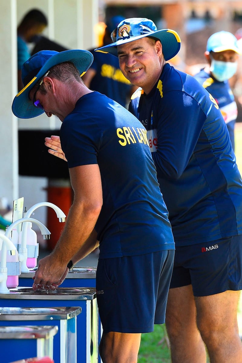 Sri Lankan head coach Mickey Arthur, right, and batting coach Grant Flower wash their hands after practice session. AFP