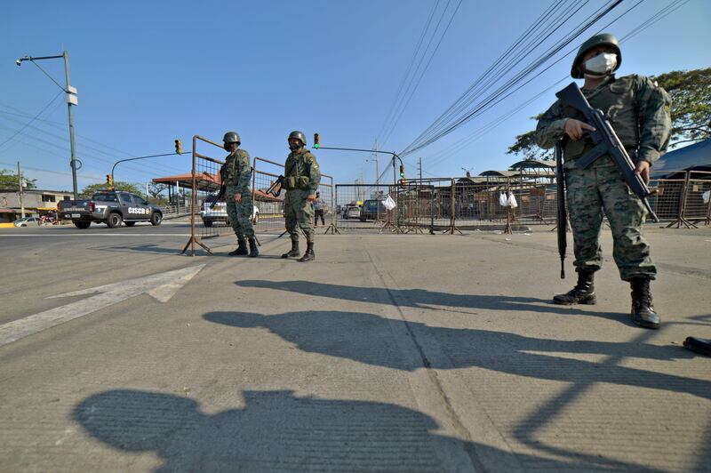 Soldiers stand guard outside the Guayas 1 prison on the outskirts of Guayaquil, Ecuador, on October 1, 2021. AFP