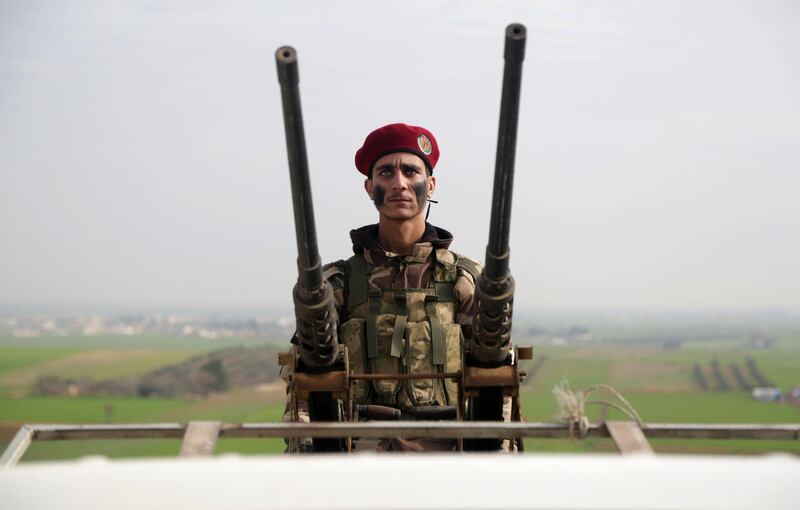 A Turkish-backed Syrian fighter looks on as he trains in a camp in the Aleppo countryside, northern Syria.  AFP