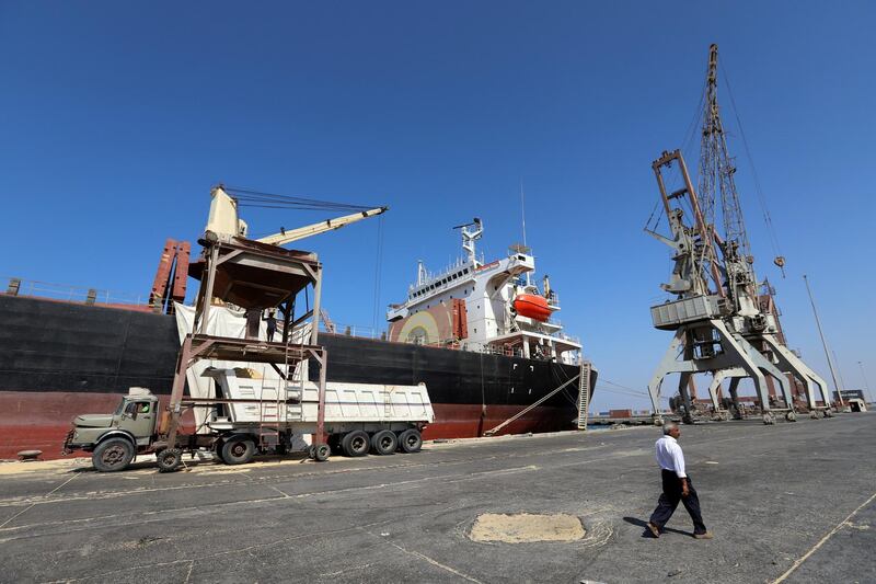 FILE PHOTO: A worker walks past a ship unloading a grain shipment at the Red Sea port of Hodeidah, Yemen January 5, 2019. Picture taken January 5, 2019. REUTERS/Abduljabbar Zeyad/File Photo