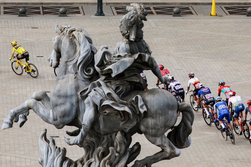 Jumbo-Visma's Danish rider Jonas Vingegaard rides past the Louvre in Paris. AFP