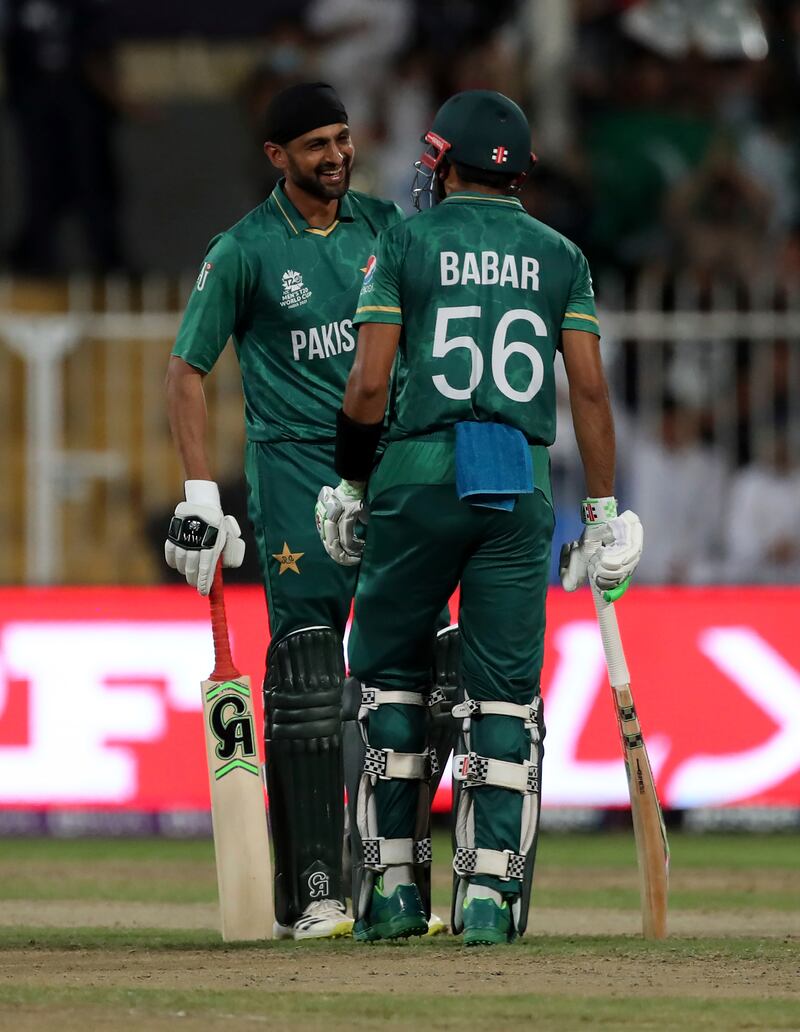 Pakistan's Shoaib Malik, left, with captain Babar Azam after hitting a boundary. AP