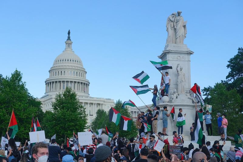 In Washington, demonstrators stand at the Peace Monument near the US Capitol during a march in support of Palestine on the 73rd anniversary of the Nakba. EPA