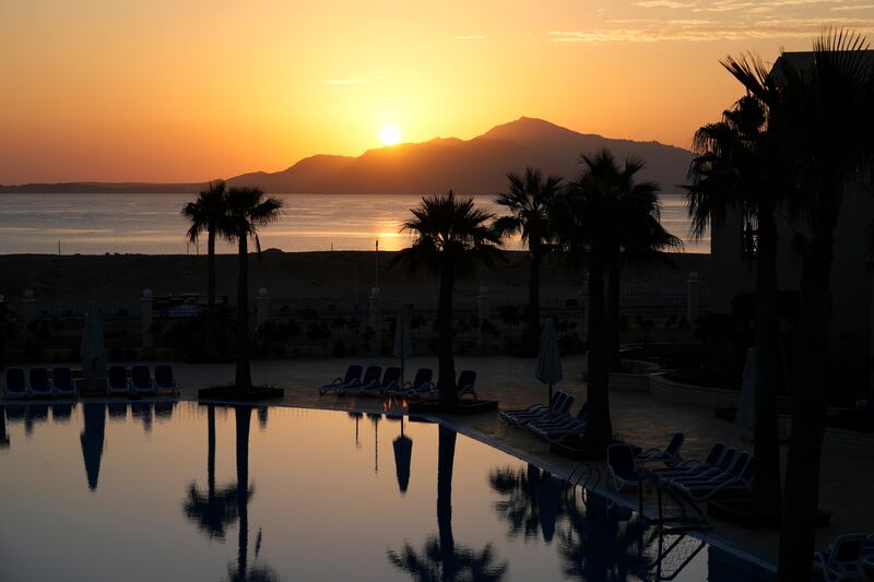 The sun rises over the beach during Cop27. AP Photo